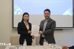 Nguyen Thi Bich Diep (left) of ASVI and Francesco Maringiò of Fondazione Italy-Vietnam sign a cooperation agreement (Photo: VNA)
