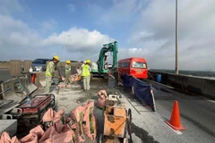 Workers close part of Long Thành Bridge for expansion joint repairs on Wednesday. The HCM City–Long Thành Expressway will be partially closed until mid-August. (Photo courtesy of VECE)