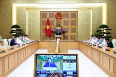 Prime Minister Pham Minh Chinh chairs an urgent meeting early on October 29 to discuss flood response and recovery efforts in the central region. (Photo: VNA)