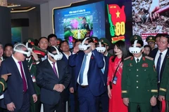 Prime Minister Pham Minh Chinh visits an exhibition area of ​​the Viettel Military Industry and Telecoms Group (Viettel). (Photo: VNA)