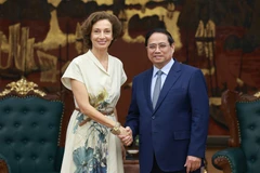 Prime Minister Pham Minh Chinh (R) receives Director-General of the United Nations Educational, Scientific and Cultural Organisation (UNESCO) Audrey Azoulay in Hanoi on June 28 (Photo: VNA)