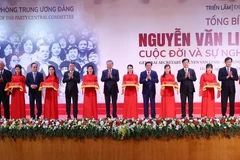 Party General Secretary To Lam (C) and other delegates cut the ribbon to launch the exhibition (Photo: VNA)