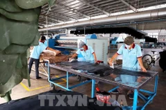 Workers produce shoe materials at a foreign-invested company in Binh Duong (now part of Ho Chi Minh City). (Photo: VNA)