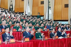 Party General Secretary To Lam (front, second, left) attends a meeting with the Military Technical Academy on March 17. (Photo: VNA)