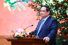 Prime Minister Pham Minh Chinh addresses the reception for outstanding intellectuals, artists, journalists, athletes, coaches and representatives of cultural and tourism enterprises on February 23. (Photo: VNA)