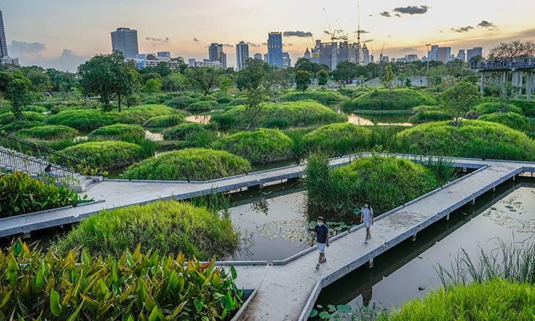 People walk on a path running through Benjakitti Park in Bangkok, Thailand. (Photo: AP) 