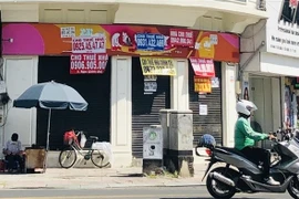 A towhouse in HCM City with banner saying "House for rent". Landlords in the city have cut down rentals due to low demand. (Photo: VNA)