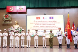 The ceremony held on August 16 to honour collectives and individuals of the Vietnamese Ministry of Public Security with prestigious orders from Laos and Cuba. (Photo: VNA)