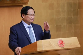 Prime Minister Pham Minh Chinh speaks at the Government's meeting on reviewing and removing bottlenecks for the implementation of the two-tier local government model on October 1. (Photo: VNA)