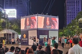 A large LED screen is set up on Nguyen Hue pedestrian street in District 1, HCM City, to enhance movie-watching experience for local residents. (Illustrative photo)