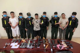 The group of Chinese nationals are arrested for illegal border crossings and the illegal transport of military-grade weapons and suspected narcotics. (Photo: VNA)
