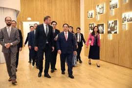 Prime Minister Pham Minh Chinh (front, first from right) and officials visit the Arvo Pärt Centre on June 6. (Photo: VNA)