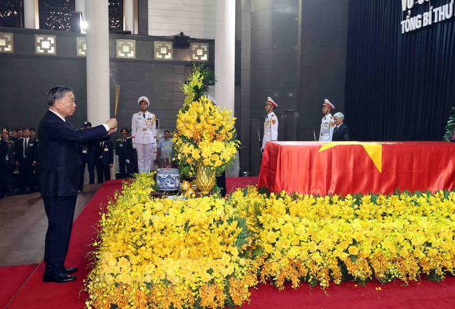 On behalf of the CPV Central Committee delegation, Politburo member and State President To Lam offers incence in commemoration of Party General Secretary Nguyen Phu Trong. (Photo: VNA) State funeral held for Party General Secretary Nguyen Phu Trong 3.jpg