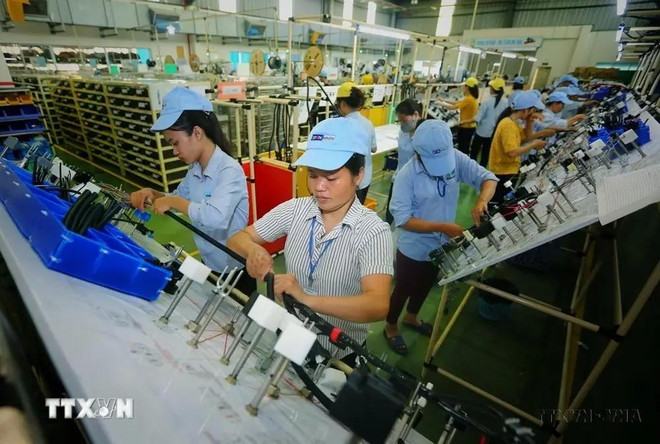 Workers produce electrical and electronic components at a factory of the Indian-invested Minda Vietnam Co. Ltd in Vinh Phuc province. (Photo: VNA) Minda Vietnam Co. Ltd.webp