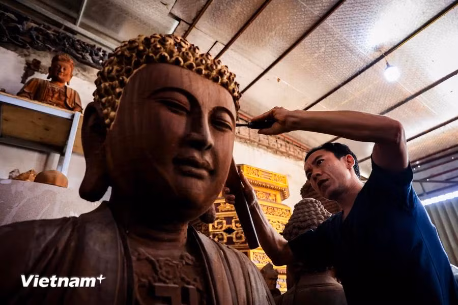 Nowadays, many young people in the village continue to uphold their ancestors’ craft of making wooden statues. (Photo: VietnamPlus)