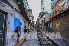 Extreme sport along the “railway” street in Hanoi