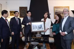 President Luong Cuong (third, left) presents a photo to Senator Isabel Allende, a daughter of the late Chilean President (Photo: VNA)