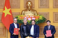 Prime Minister Phạm Minh Chính (second from right) and NVIDIA founder and chief executive officer Jensen Huang (second from left) witness the signing of a cooperation agreement on artificial intelligence research between Vietnamese government and NVIDIA Group. (Photo: VNA)