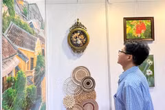 A visitor to the Hong Kong art expo watches Vietnamese products on display. (Photo: VNA)
