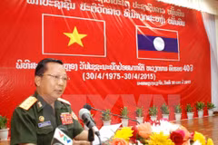 Lao Deputy Defence Minister Chansamon Channhalat delivers addresses the event (Photo: VNA)