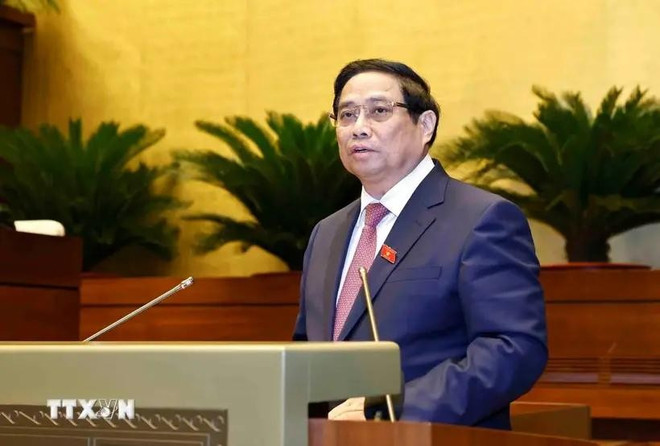 Prime Minister Pham Minh Chinh delivers a report at the ongoing 8th session of the 15th National Assembly in Hanoi on October 21. (Photo: VNA) PM.jpg
