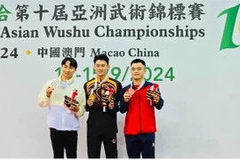 Nong Van Huu (left) poses with other medallists of the men's nanquan event at the Asian Wushu Championships on September 12 in Macau, China. (Photo of organisers)