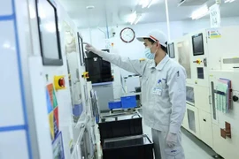 Workers at Meiko Vietnam, a company specialised in manufacturing printed circuit boards at the Thach That industrial park in Hanoi. (Photo: laodong.vn)