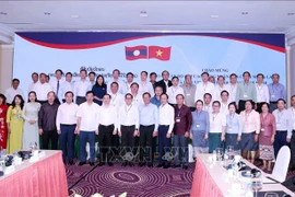HCM City and Lao participants of the meeting pose for a group photo (Source: VNA)