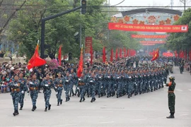 The cyber warfare unit participates in a parade on the street. (Photo: VNA)