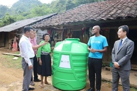 One of the 456 plastic water storage tanks is presented to a local in Cao Bang (Photo: VNA)