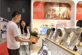 A buyer surveys supplies at the show. (Photo: VNA)