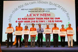 Tokens of scholarships for child victims of the AO/dioxin disaster presented at the ceremony (Photo: VNA)