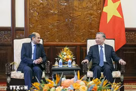 President To Lam (right) receives Indian Ambassador to Vietnam Sandeep Arya in Hanoi on June 26 (Photo: VNA)
