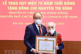  Former vice president honoured with 75-year Party membership badge