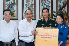 State President visits families of contributors to national reunification in Hanoi