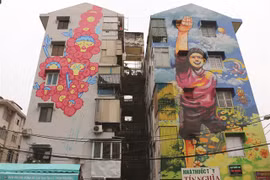 Colourful murals cover old buildings in HCM City