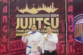 Jujitsu fighter Nguyen Thị Thanh Truc (left) and her coach pose for a photo after winning gold at the 2024 Thailand Open Grand Prix. (Photo of Thanh Truc)