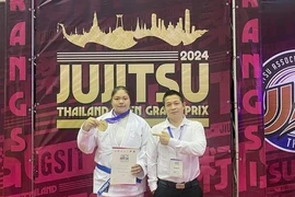 Jujitsu fighter Nguyen Thị Thanh Truc (left) and her coach pose for a photo after winning gold at the 2024 Thailand Open Grand Prix. (Photo of Thanh Truc)