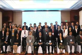 Participants at the international forum on socialism pose for a group photo (Photo: VNA)