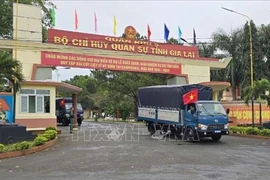 Convoy carrying the K52 search team departs the Gia Lai Military Command headquarters for their mission in Cambodia (Photo: VNA).