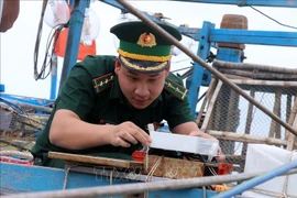 An officer checks a VMS device (Photo: VNA)