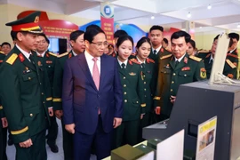 PM Pham Minh Chinh visits the area displaying the MTA's products (Photo: VNA)