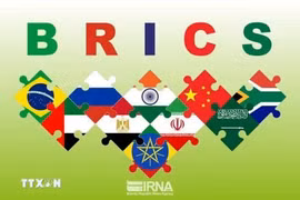 The BRICS symbol with the flags of member countries and nations invited to join the group. (Photo: IRNA/VNA)