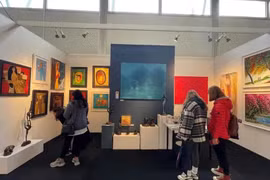 Visitors look at artworks by 13 Vietnamese painters at the Affordable Art Fair in London.(Photo: VNA)