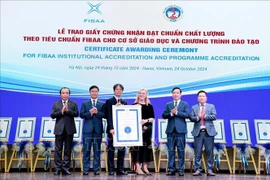 FIBAA General Director Diane Freiberger (third, right) hands over the certificate to the National Economics University (NEU) in Hanoi on October 24. (Photo: VNA)