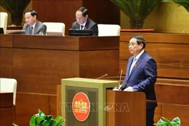 PM Pham Minh Chinh fields legislators' questions at the 15th NA's ongoing 8th session on November 12. (Photo: VNA)