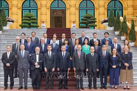 President To Lam (fifth from left) and EU ambassadors and chargés d’affaires pose for a photo in Hanoi on June 7. (Photo: VNA)