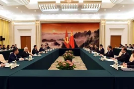 The meeting between the CPV delegation and Wang Huning, member of the Standing Committee of the CPC Central Committee’s Political Bureau and Chairman of the National Committee of the Chinese People’s National Political Consultative Conference, in Beijing on June 13 (Photo: VNA)