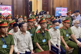 Defendants involved in the Vietnam Register corruption case at the first-instance trial opened in HCM City on July 18. (Photo: VNA)
