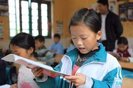 Young Vietnamese students improving reading abilities 